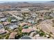 Elevated aerial view showcases a beautiful desert community with meticulously landscaped homes and desert views at 7687 W Pebble Rd, Las Vegas, NV 89113