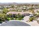 Expansive aerial view of a single Gathering home showcasing a circular driveway, three-car garage, and desert landscaping at 7687 W Pebble Rd, Las Vegas, NV 89113