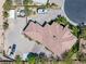 Bird's eye view of a house with intricate roof, well-maintained landscaping, circular driveway, and RV parking at 7687 W Pebble Rd, Las Vegas, NV 89113