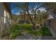 Backyard featuring lush grass, mature trees, and stone pathway at 7687 W Pebble Rd, Las Vegas, NV 89113