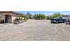 Large gravel backyard with a parked pick up truck and some landscaping materials at 7687 W Pebble Rd, Las Vegas, NV 89113