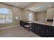 This bathroom has double sinks, a large mirror, dark wood cabinetry and lots of natural light at 7687 W Pebble Rd, Las Vegas, NV 89113