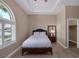Cozy bedroom with wood floors, tray ceiling, and shuttered window at 7687 W Pebble Rd, Las Vegas, NV 89113