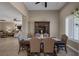 Spacious dining area with an elegant table, stylish chairs, and a view of the living room at 7687 W Pebble Rd, Las Vegas, NV 89113