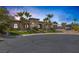 Stunning single story home with stone accents and meticulously landscaped front yard with tall palm trees at 7687 W Pebble Rd, Las Vegas, NV 89113