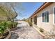 Charming single story home featuring a long brick-paved driveway and pathway leading to a welcoming outdoor patio at 7687 W Pebble Rd, Las Vegas, NV 89113