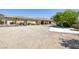 Wide shot of home with gravel backyard, concrete driveway, and desert landscaping at 7687 W Pebble Rd, Las Vegas, NV 89113