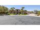 Stately front exterior of the home with palm trees and a circular driveway at 7687 W Pebble Rd, Las Vegas, NV 89113