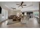 Open concept living room and kitchen offers comfortable seating, ceiling fans and access to the backyard at 7687 W Pebble Rd, Las Vegas, NV 89113