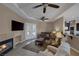 Comfortable living room with a fireplace, ceiling fan, neutral walls, and access to the outdoors at 7687 W Pebble Rd, Las Vegas, NV 89113