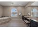 Relax in this luxurious main bathroom with a soaking tub, double sinks, and large mirror at 7687 W Pebble Rd, Las Vegas, NV 89113