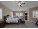 Comfortable bedroom featuring a large bed, seating, plantation shutters, and ample natural light at 7687 W Pebble Rd, Las Vegas, NV 89113