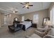 Spacious main bedroom boasts a seating area, ceiling fans, and neutral decor at 7687 W Pebble Rd, Las Vegas, NV 89113