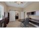 Well-lit office space with built-in shelving, desk space, and sliding barn door to en-suite bathroom at 7687 W Pebble Rd, Las Vegas, NV 89113