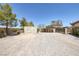 Expansive parking area featuring durable gravel, a storage container and gated access at 7687 W Pebble Rd, Las Vegas, NV 89113