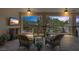 Cozy outdoor patio with comfortable seating, ceiling fans, and a view of the garden at 7687 W Pebble Rd, Las Vegas, NV 89113