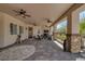 Large covered patio features stone columns, ceiling fans, and outdoor seating for relaxing or entertaining at 7687 W Pebble Rd, Las Vegas, NV 89113