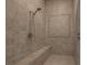 Walk in shower with a built-in seat and decorative tile surround at 7687 W Pebble Rd, Las Vegas, NV 89113