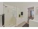 Modern bathroom with a sleek glass shower, a soaking tub, and a view into another room at 7901 Idledale Ct # 102, Las Vegas, NV 89145
