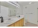 Bathroom featuring double sinks, framed mirrors, and a walk-in shower with glass door at 7901 Idledale Ct # 102, Las Vegas, NV 89145