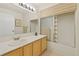 Bathroom featuring a single sink vanity, large mirror, and a shower-tub combination at 7901 Idledale Ct # 102, Las Vegas, NV 89145