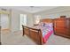 Comfortable bedroom featuring a wood bed frame, dresser, and neutral carpet at 7901 Idledale Ct # 102, Las Vegas, NV 89145