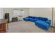 Bedroom with a large blue couch and natural light from a bright window on neutral carpet at 7901 Idledale Ct # 102, Las Vegas, NV 89145