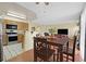 Dining area with table and seating for four, adjacent to an open kitchen with modern appliances at 7901 Idledale Ct # 102, Las Vegas, NV 89145