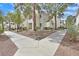 Inviting condo exterior with mature trees, meticulous landscaping, and walkways at 7901 Idledale Ct # 102, Las Vegas, NV 89145