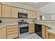 Kitchen with stainless steel appliances and plentiful cabinet space on white tile floors at 7901 Idledale Ct # 102, Las Vegas, NV 89145