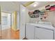 Convenient laundry room with washer, dryer, and storage shelves for organized living at 7901 Idledale Ct # 102, Las Vegas, NV 89145