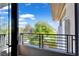 Balcony with black metal railing has treetop and cloud views at 9 Greely Club Trl, Henderson, NV 89052