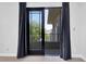 A balcony with black-out curtains, offering picturesque views and natural light at 9 Greely Club Trl, Henderson, NV 89052