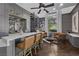 Stylish bar area with custom cabinetry, a spiral staircase, and abundant natural light from a large window at 9 Greely Club Trl, Henderson, NV 89052