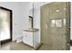 Modern bathroom featuring a glass shower and sleek white vanity with a stone countertop at 9 Greely Club Trl, Henderson, NV 89052
