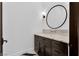 Stylish powder room featuring a floating vanity with a round mirror at 9 Greely Club Trl, Henderson, NV 89052