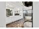 A luxury bathroom featuring a glass shower, large mirror, modern fixtures, and a soaking tub at 9 Greely Club Trl, Henderson, NV 89052