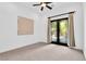 Bright bedroom featuring neutral carpet and patio door to the backyard at 9 Greely Club Trl, Henderson, NV 89052