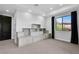 Bright bedroom featuring custom built-in shelving, neutral carpet, and large window with black-out curtains at 9 Greely Club Trl, Henderson, NV 89052