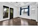 Bright bedroom with hardwood floors, built-in shelving, and backyard access at 9 Greely Club Trl, Henderson, NV 89052