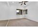Cozy bedroom with large windows, carpet flooring, and a ceiling fan for added comfort at 9 Greely Club Trl, Henderson, NV 89052