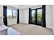 Bedroom with black-out curtains on the window and sliding doors to an outside balcony at 9 Greely Club Trl, Henderson, NV 89052