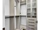 Walk-in closet with wood-toned shelving and glass door at 9 Greely Club Trl, Henderson, NV 89052