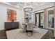 Bright dining room featuring modern chandelier, dark wood floors, and access to outdoor space at 9 Greely Club Trl, Henderson, NV 89052