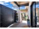Welcoming entrance features a modern steel gate, manicured shrubbery, and sleek architectural details at 9 Greely Club Trl, Henderson, NV 89052