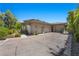 Contemporary home featuring a three-car garage, private gated entry, and desert landscaping in a quiet neighborhood at 9 Greely Club Trl, Henderson, NV 89052