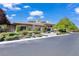 Beautiful single-story home with manicured landscaping, mature trees, and a paved street at 9 Greely Club Trl, Henderson, NV 89052