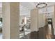 Elegant hallway showcasing stone columns, wood floors, and views into the living spaces at 9 Greely Club Trl, Henderson, NV 89052