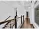 Bright hallway featuring hardwood floors, contemporary railings, and ample natural light at 9 Greely Club Trl, Henderson, NV 89052