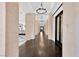 Hallway with dark hardwood flooring, columns and chandelier lighting at 9 Greely Club Trl, Henderson, NV 89052